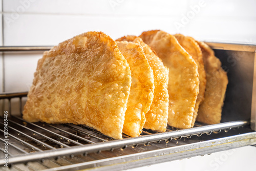 Fresh crispy halal tatar chebureks draining after frying
