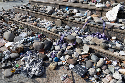 Several stones bearing the names of deceased individuals were placed in their honor on the steps of a monument in Plaza de Mayo.