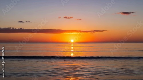 Golden Sunset Over Calm Ocean Waves Reflecting Fiery Sky.