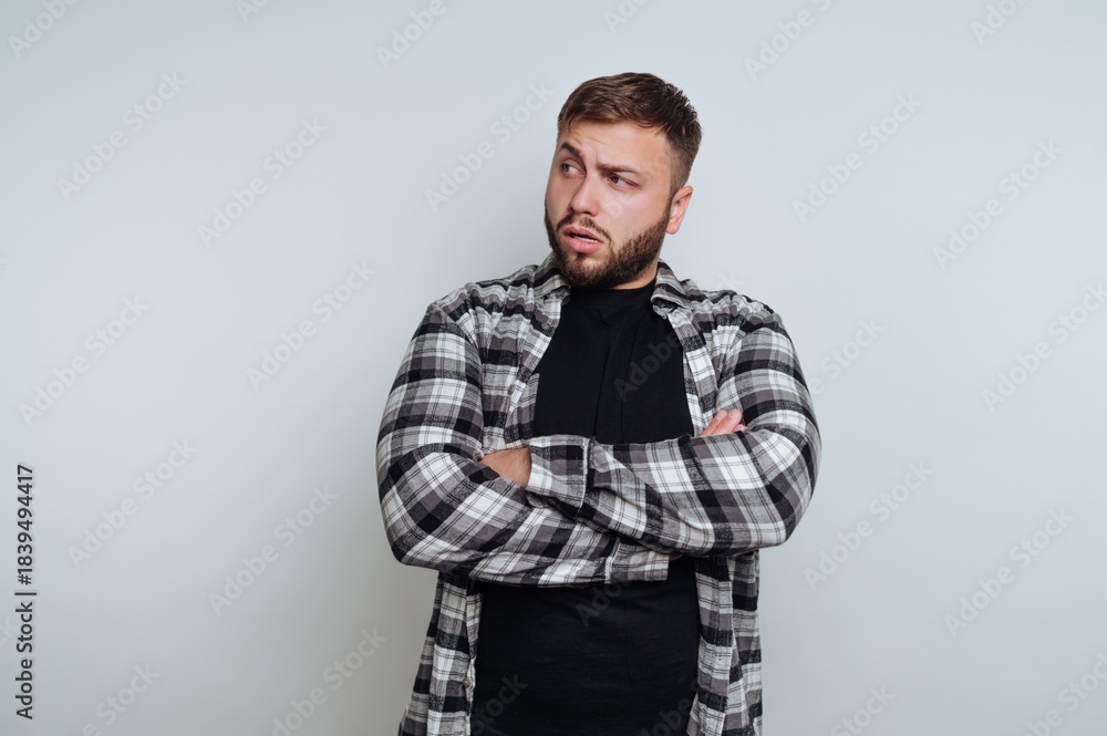 Obraz premium Man in Plaid Shirt Looking to the Side