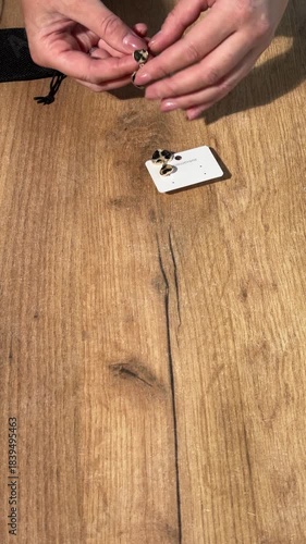 A woman reviews leopard print earrings. Vertical video.