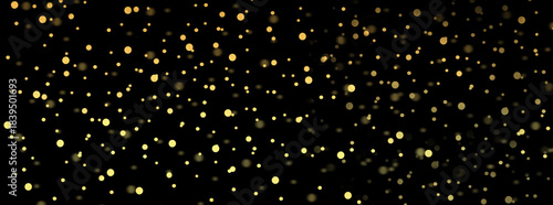Golden snowfall on a black background. Golden circles of varying sizes and shades with blur.