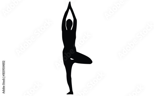 Silhouette of woman in tree yoga pose, standing on one leg with hands up