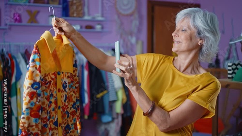 Senior woman selling clothes and accessories online. Managing a Small business during the seniority period. Listing articles and products to sell on the selling platforms.	