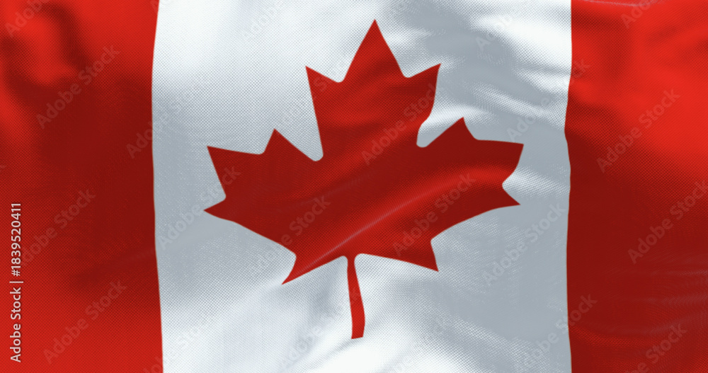 Naklejka premium Close-up of Canada national flag waving in the wind on a clear day