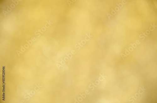 Yellow glow. Abstract background. Light and bokeh. A bright holiday template. Golden background for congratulations. A screen saver with a Bokeh.