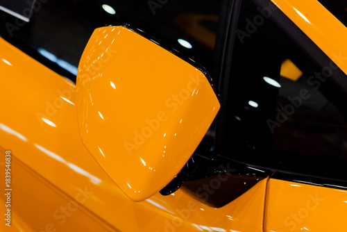close-up of the side mirror of a yellow car
