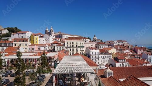 Rooftop view of a European city with colorful buildings and a church