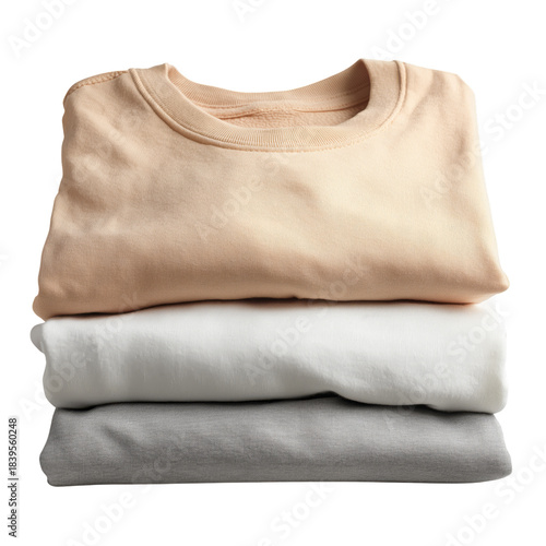 Three Rolled Shirts Stacked on a Table With a Simple Design and Casual Colors