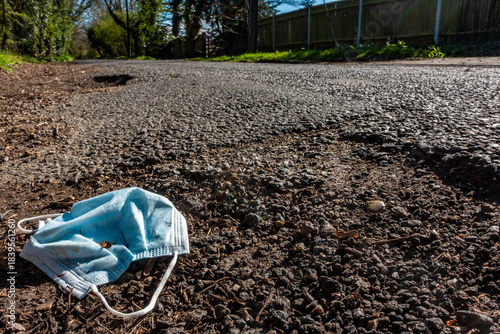 Discarded Face Mask at the Side of a Road