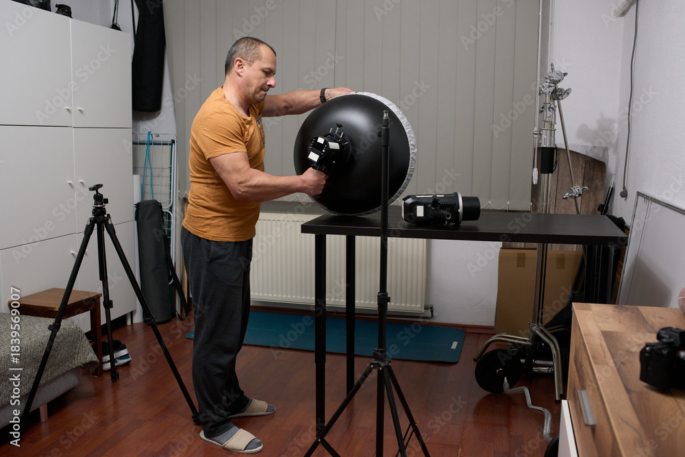 Obraz premium Photographer sets up studio lighting