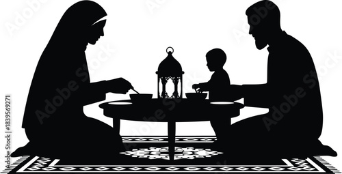 Silhouetted family sharing a meal together at a low table