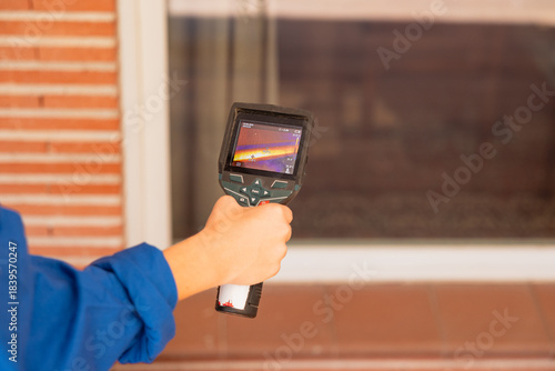 Worker performing thermal inspection finding heat leak
