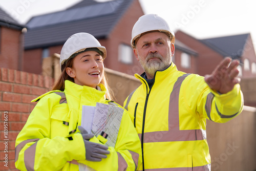 Photography Male construction works project manager and young female site engineer collabora