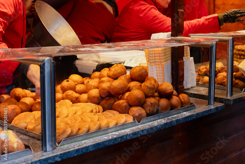 Pile of Fresh Dutch Traditional Fried Dough Oliebollen for Sale. Classic Winter Street Food in the Netherlands.