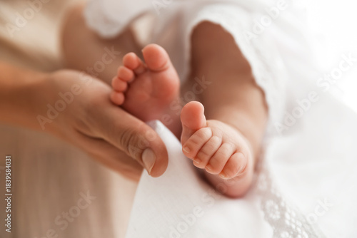 Photos Sacrament of baptism. Woman holding little baby indoors, closeup