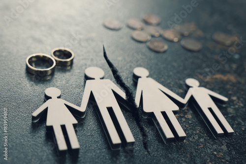Divorce and alimony concept. Family figure with crack between wife and husband on table