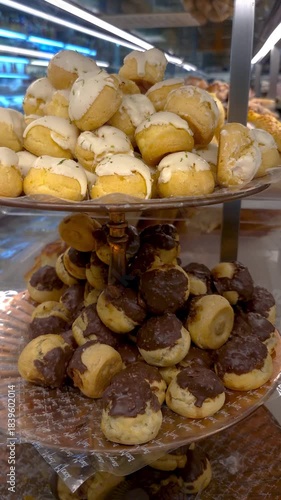 A clerk picking up a carolina, a traditional pastry from Brazilian bakeries.