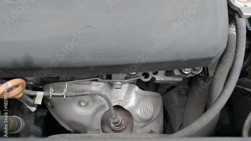 Engine startup close-up with mechanical sounds as the motor ignites and begins running under the hood