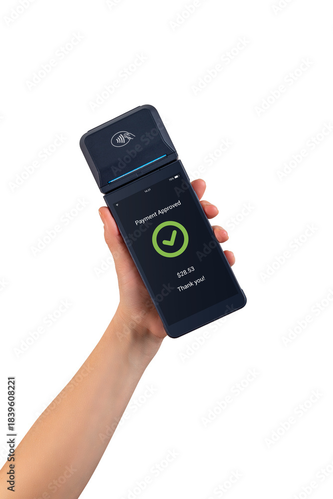 Obraz premium Hand holding wireless POS terminal displaying payment approved screen, showing modern digital checkout and cashless transaction technology on white background