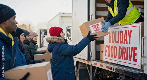 People Volunteering at a Holiday Food Drive Loading Boxes into a Truck for Community Support and Charity Initiatives