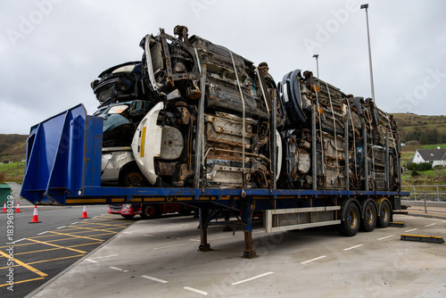 Commercial trailer full of flattened, compressed, cars waiting at a ferry terminal, Uig, Isle of Skye, Scotland, UK.

