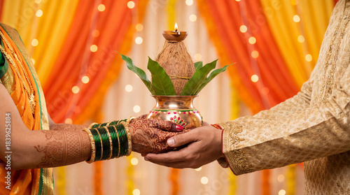 a couple's hands holding a kalash