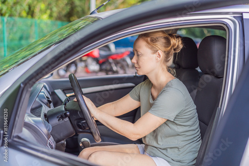 Fotografia Woman cleaning her car, organizing seats and removing clutter to keep the vehicle tidy