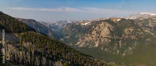 A view of a valley along the Beartooth Highway in Montana with a haze in the background from wildfires.