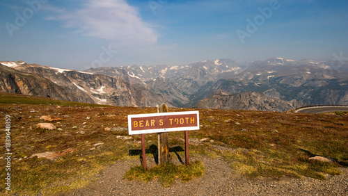 A sign along the Beartooth Highway that says Bear's Took with the mountains in the background.