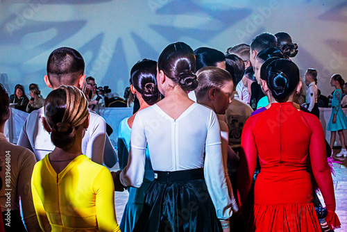 Girls with slicked-back hair and boys before a ballroom dance tournament