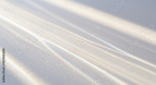 白い背景に斜めに差し込む明るい自然光が美しい光の線と複雑な屈折模様を描き出しミニマルで穏やかな美しさを醸し出す. AI Generated