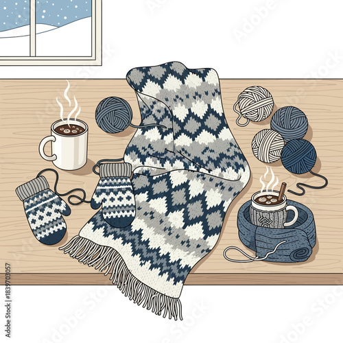 Cozy winter knitting scene with warm woolen socks and sweater on wooden table