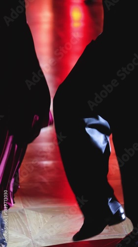 Tangueros couples dancing traditional latin argentinian dance milonga in a ballroom, tango salsa bachata kizomba lesson in red and purple lights, rehearsal evening dance school class festival