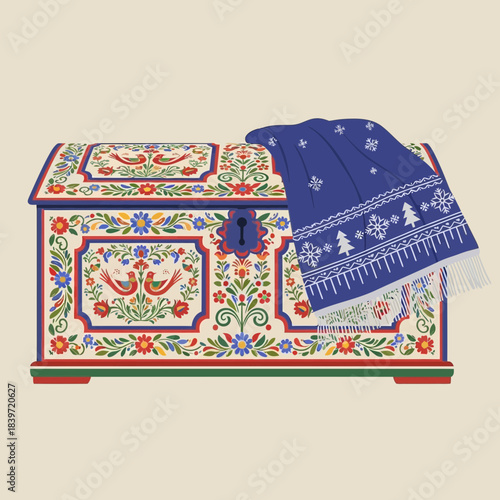 Traditional embroidered textile chest with blue shawl and intricate floral design
