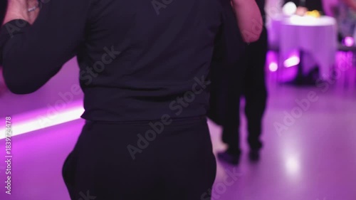 Tangueros couples dancing traditional latin argentinian dance milonga in a ballroom, tango salsa bachata kizomba lesson in red and purple lights, rehearsal evening dance school class festival