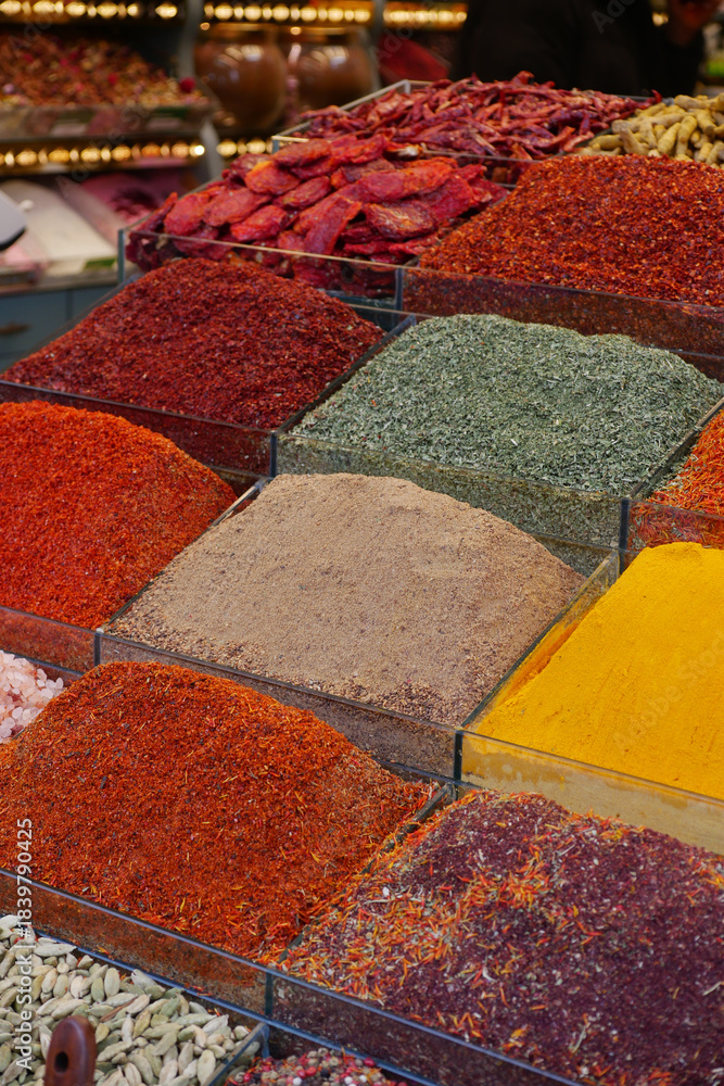 Fototapeta premium Colorful display of spices at market in afternoon light