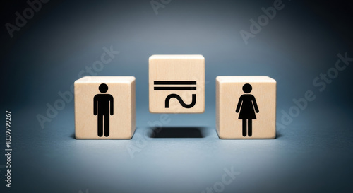 Beige wooden blocks with man equals woman concept on a neutral background illustrating gender equality, balance and fairness, with representation of symbols.