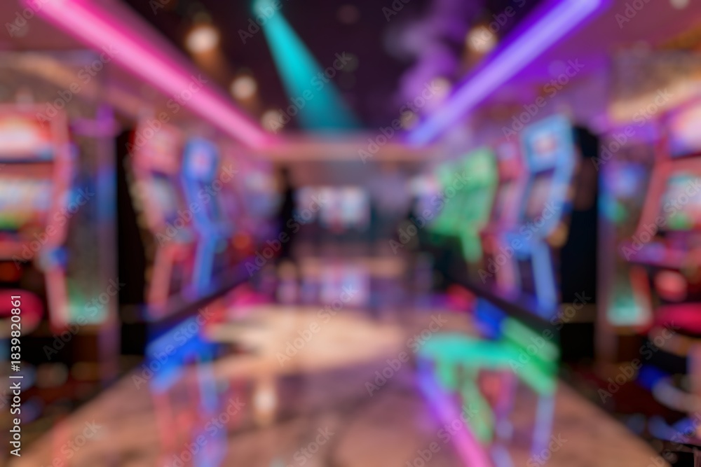 Obraz premium Blur image of several slot machines in a casino with vibrant lights and players in the background. The blur creates a sense of motion and excitement in a high-energy environment.