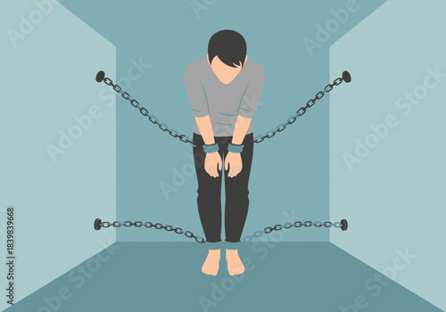Man bound by chains in a confined space.