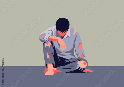 Person sitting with head down wearing torn clothes.