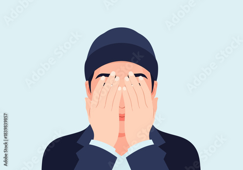 Person wearing a hat covers face with hands, eyes closed.