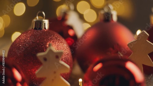 Festive Red Christmas Ornaments with Twinkling Golden Bokeh Lights and Wooden Tree Decoration
