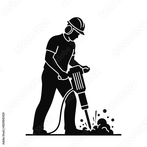 Silhouette of a construction worker using a jackhammer on the ground.