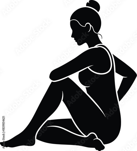 Silhouette of a woman sitting in a relaxed pose with hair in a bun