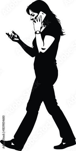 Silhouette of a woman walking while talking on a mobile phone