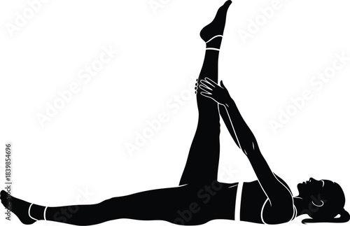 Silhouette of a woman stretching one leg while lying down