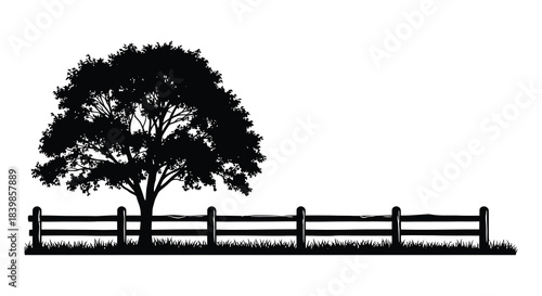 A peaceful landscape featuring a tree and a wooden fence in stark silhouette