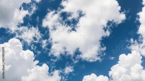 A vibrant blue sky with fluffy white clouds, offering a sunny and serene atmosphere