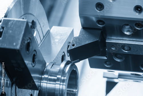 The CNC lathe machine forming cutting the metal tube parts in the light blue scene.